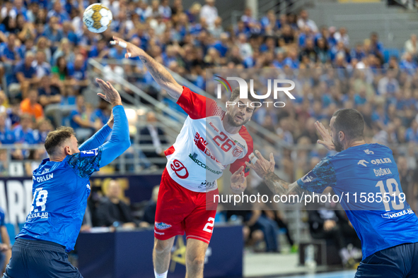 Leon Susnja and  Haniel Vinicius Inoue Langaro are playing during the  EHF Champions League Men match between  Orlen Wisla Plock and Dinamo...