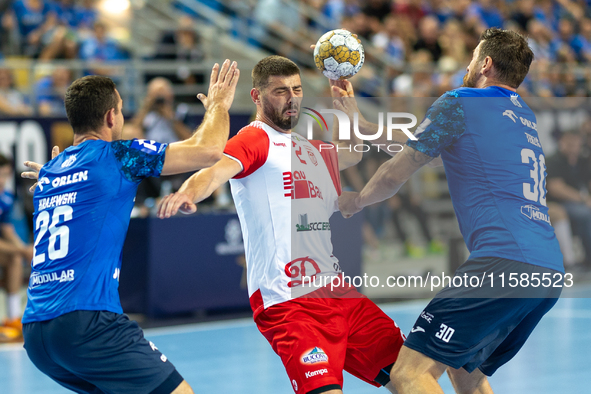 Przemyslaw Krajewski, Branko Vujovic and Mirsad Terzic are playing during the  EHF Champions League Men match between  Orlen Wisla Plock and...