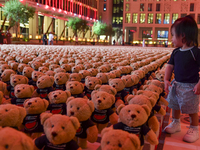 A young child looks at an installation of teddy bears titled ''Echo of Lost Innocence'' at the Barahat Mashaireb open-air gallery to draw at...