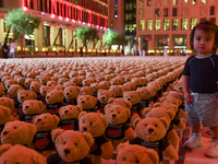 A young child looks at an installation of teddy bears titled ''Echo of Lost Innocence'' at the Barahat Mashaireb open-air gallery to draw at...