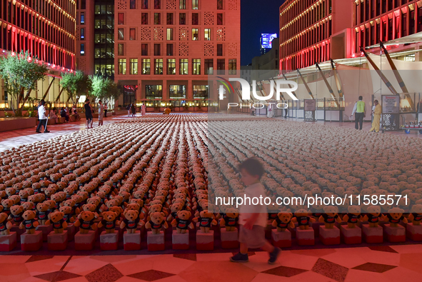 A young child looks at an installation of teddy bears titled ''Echo of Lost Innocence'' at the Barahat Mashaireb open-air gallery to draw at...