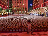 A young child looks at an installation of teddy bears titled ''Echo of Lost Innocence'' at the Barahat Mashaireb open-air gallery to draw at...