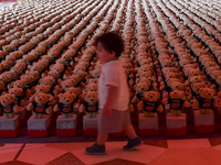 A young child looks at an installation of teddy bears titled ''Echo of Lost Innocence'' at the Barahat Mashaireb open-air gallery to draw at...