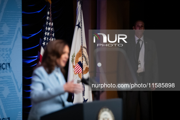 A Secret Service agent watches as Vice President and Democratic presidential nominee Kamala Harris delivers remarks at the annual conference...