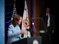 A Secret Service agent watches as Vice President and Democratic presidential nominee Kamala Harris delivers remarks at the annual conference...