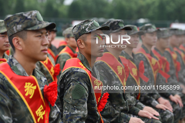 Young conscripts attend a send-off ceremony for new recruits in Fuyang, China, on September 19, 2024. 