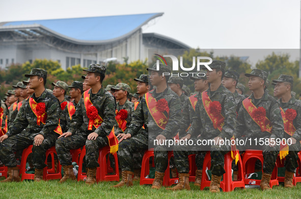 Young conscripts attend a send-off ceremony for new recruits in Fuyang, China, on September 19, 2024. 