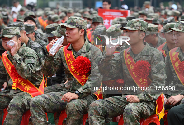 Young conscripts attend a send-off ceremony for new recruits in Fuyang, China, on September 19, 2024. 