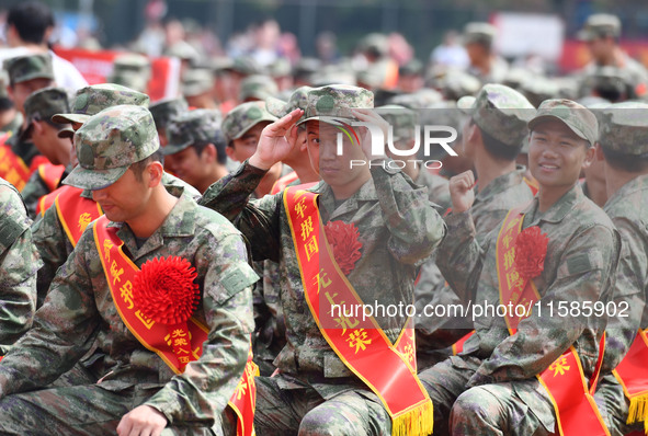 Young conscripts attend a send-off ceremony for new recruits in Fuyang, China, on September 19, 2024. 