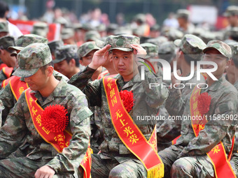 Young conscripts attend a send-off ceremony for new recruits in Fuyang, China, on September 19, 2024. (