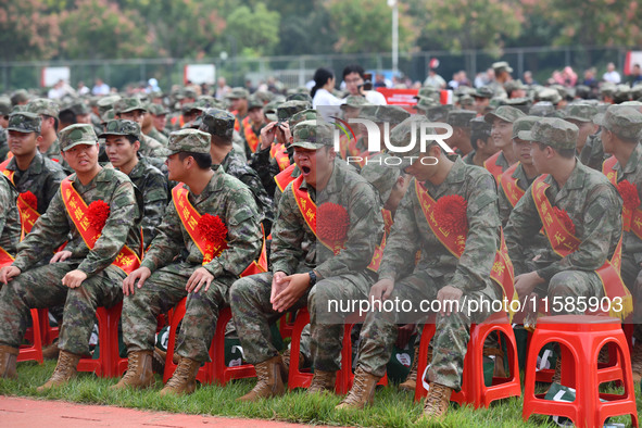 Young conscripts attend a send-off ceremony for new recruits in Fuyang, China, on September 19, 2024. 