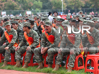 Young conscripts attend a send-off ceremony for new recruits in Fuyang, China, on September 19, 2024. (