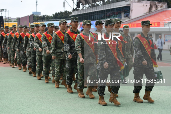 Young conscripts attend a send-off ceremony for new recruits in Fuyang, China, on September 19, 2024. 