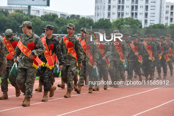 Young conscripts attend a send-off ceremony for new recruits in Fuyang, China, on September 19, 2024. 