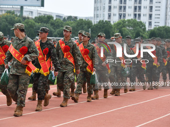 Young conscripts attend a send-off ceremony for new recruits in Fuyang, China, on September 19, 2024. (