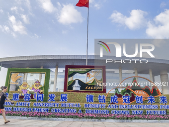 People walk past a sign for the ASEAN Expo in Nanning, China, on September 18, 2024. (