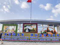 People walk past a sign for the ASEAN Expo in Nanning, China, on September 18, 2024. (