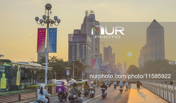 People walk past a sign for the ASEAN Expo in Nanning, China, on September 18, 2024. 