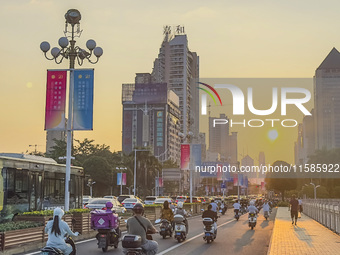 People walk past a sign for the ASEAN Expo in Nanning, China, on September 18, 2024. (