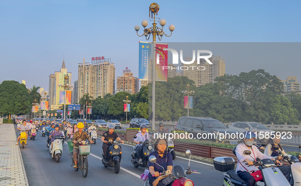 People walk past a sign for the ASEAN Expo in Nanning, China, on September 18, 2024. 