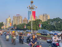 People walk past a sign for the ASEAN Expo in Nanning, China, on September 18, 2024. (