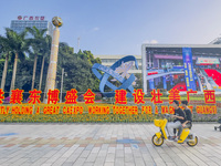 People walk past a sign for the ASEAN Expo in Nanning, China, on September 18, 2024. (