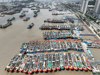 A large number of fishing boats moor at Shenjiamen Fishing Port to take shelter from Typhoon Pulasan in Zhoushan, China, on September 19, 20...