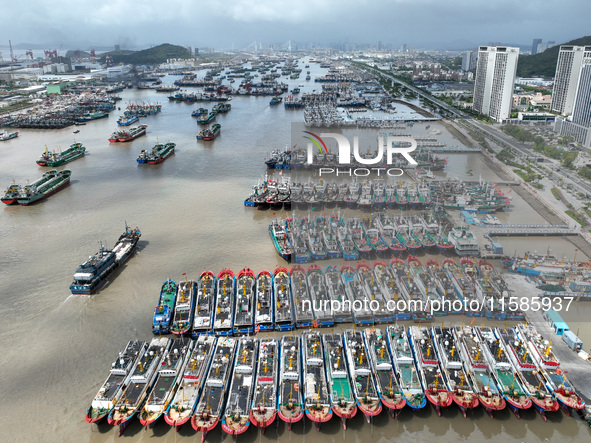 A large number of fishing boats moor at Shenjiamen Fishing Port to take shelter from Typhoon Pulasan in Zhoushan, China, on September 19, 20...