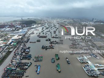 A large number of fishing boats moor at Shenjiamen Fishing Port to take shelter from Typhoon Pulasan in Zhoushan, China, on September 19, 20...