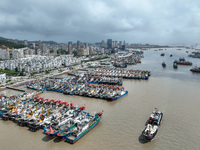 A large number of fishing boats moor at Shenjiamen Fishing Port to take shelter from Typhoon Pulasan in Zhoushan, China, on September 19, 20...