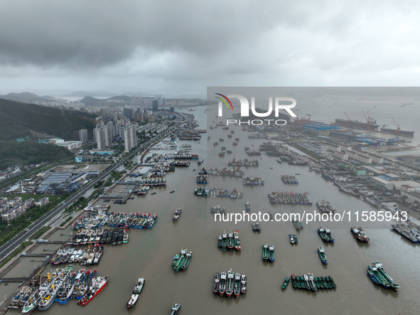 A large number of fishing boats moor at Shenjiamen Fishing Port to take shelter from Typhoon Pulasan in Zhoushan, China, on September 19, 20...