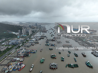 A large number of fishing boats moor at Shenjiamen Fishing Port to take shelter from Typhoon Pulasan in Zhoushan, China, on September 19, 20...