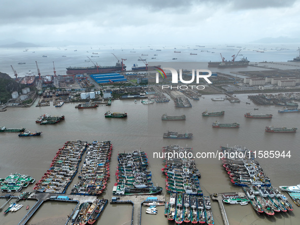 A large number of fishing boats moor at Shenjiamen Fishing Port to take shelter from Typhoon Pulasan in Zhoushan, China, on September 19, 20...