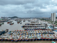 A large number of fishing boats moor at Shenjiamen Fishing Port to take shelter from Typhoon Pulasan in Zhoushan, China, on September 19, 20...