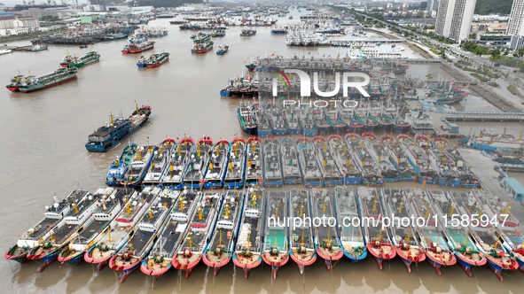 A large number of fishing boats moor at Shenjiamen Fishing Port to take shelter from Typhoon Pulasan in Zhoushan, China, on September 19, 20...