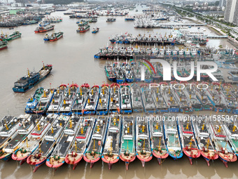 A large number of fishing boats moor at Shenjiamen Fishing Port to take shelter from Typhoon Pulasan in Zhoushan, China, on September 19, 20...