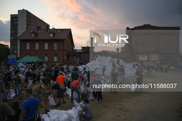 People and territorial defense forces prepare sandbags to tackle the ongoing high water level throughout the region in Olawa, near Wroclaw,...