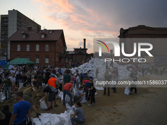 People and territorial defense forces prepare sandbags to tackle the ongoing high water level throughout the region in Olawa, near Wroclaw,...