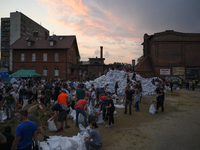 People and territorial defense forces prepare sandbags to tackle the ongoing high water level throughout the region in Olawa, near Wroclaw,...