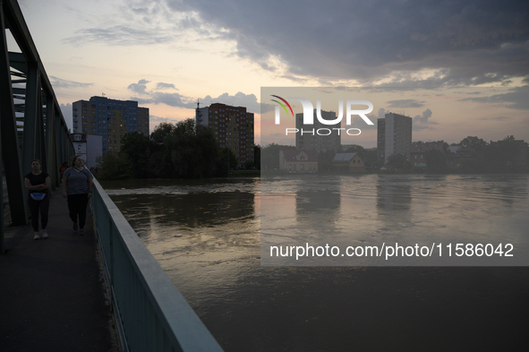 People walk on a bridge above the Oder River in Olawa, near Wroclaw, Poland, on September 18, 2024. Emergency services, including fire depar...