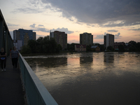 People walk on a bridge above the Oder River in Olawa, near Wroclaw, Poland, on September 18, 2024. Emergency services, including fire depar...