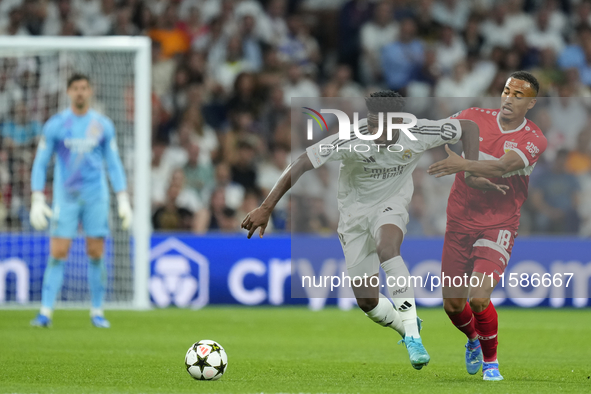 Aurelien Tchouameni defensive midfield of Real Madrid and France and Jamie Leweling right winger of Stuttgart and Germany compete for the ba...