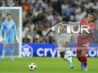 Aurelien Tchouameni defensive midfield of Real Madrid and France and Jamie Leweling right winger of Stuttgart and Germany compete for the ba...