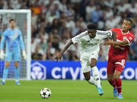 Aurelien Tchouameni defensive midfield of Real Madrid and France and Jamie Leweling right winger of Stuttgart and Germany compete for the ba...