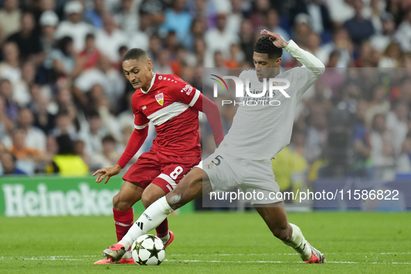 Jude Bellingham central midfield of Real Madrid and England and Enzo Millot attacking midfield of Stuttgart and France compete for the ball...