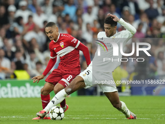 Jude Bellingham central midfield of Real Madrid and England and Enzo Millot attacking midfield of Stuttgart and France compete for the ball...