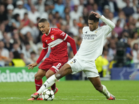 Jude Bellingham central midfield of Real Madrid and England and Enzo Millot attacking midfield of Stuttgart and France compete for the ball...