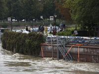 People walk next to sandbags during high waters in the Oder River in Wroclaw, Poland, on September 19, 2024. (