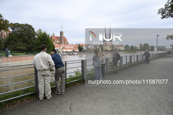 People take pictures of the high water level in the Oder River in Wroclaw, Poland, on September 19, 2024. 