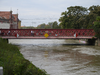 People walk on a bridge during a high water level in the Oder River in Wroclaw, Poland, on September 19, 2024. (